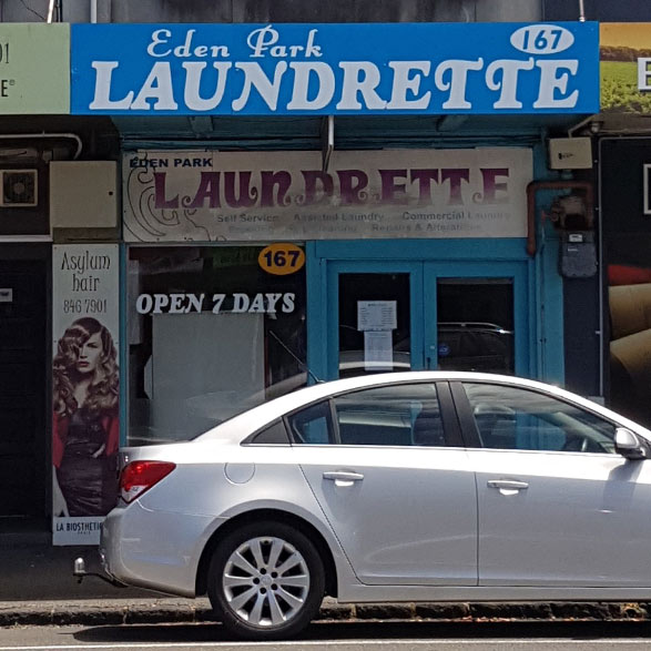 Gray Car in front of the Balmoral Drycleaners Store